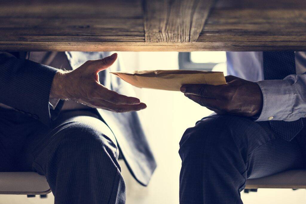 business-people-sending-documents-under-the-table-PB2TXRA-1024x683 business-people-sending-documents-under-the-table-PB2TXRA-1024x683