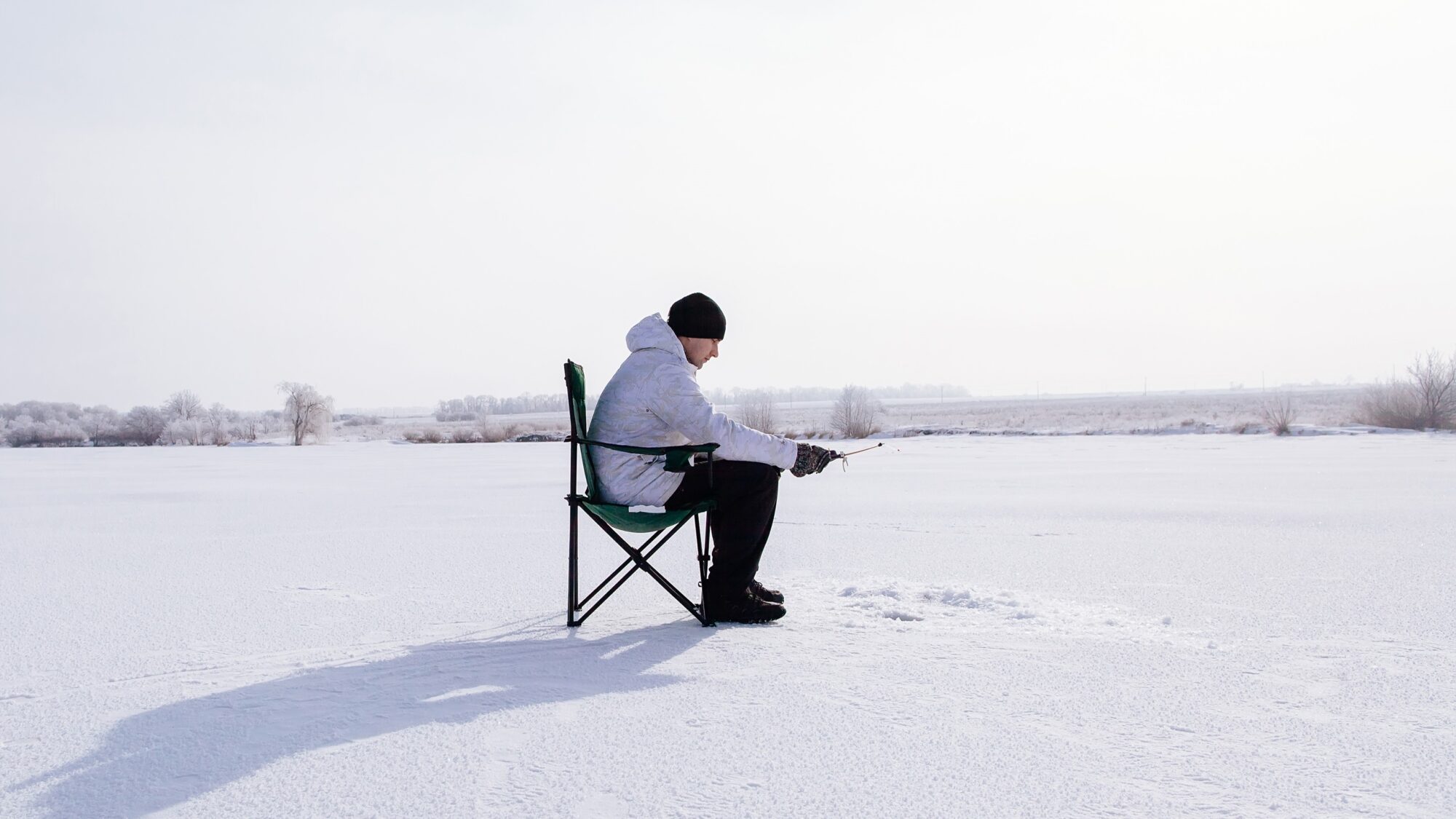 winter fisherman on frozen lake