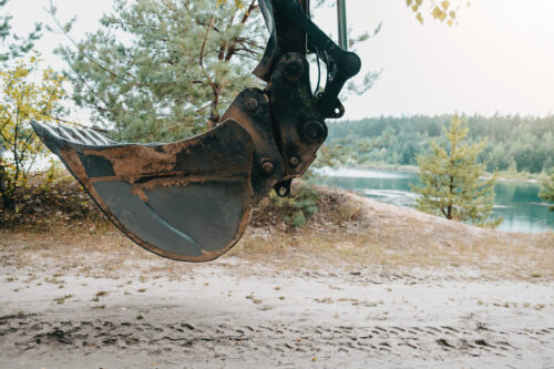 Large bucket on construction site or quarry. Mining heavy machinery details.
