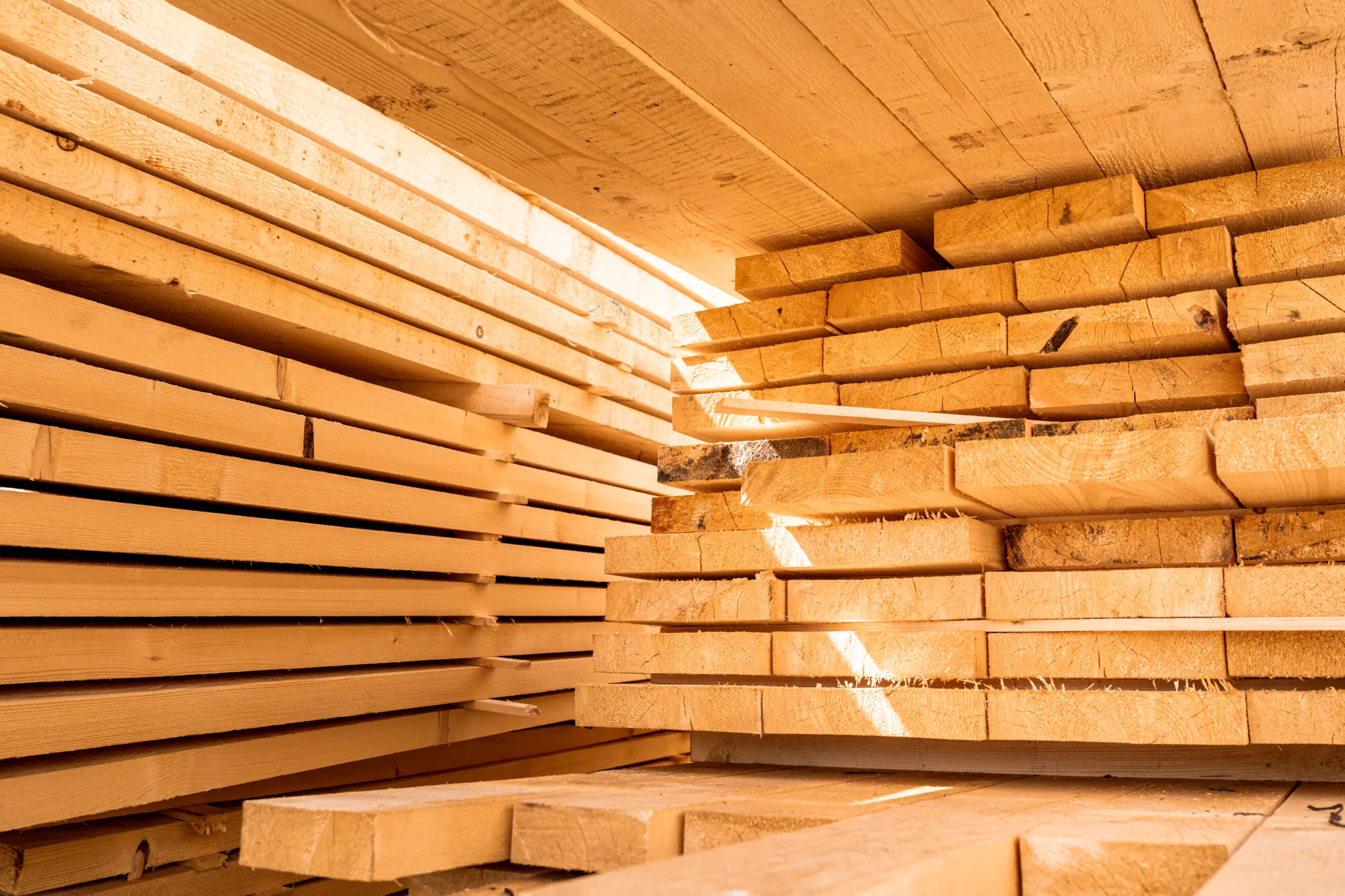 Stack of construction wood planks prepared for build a house