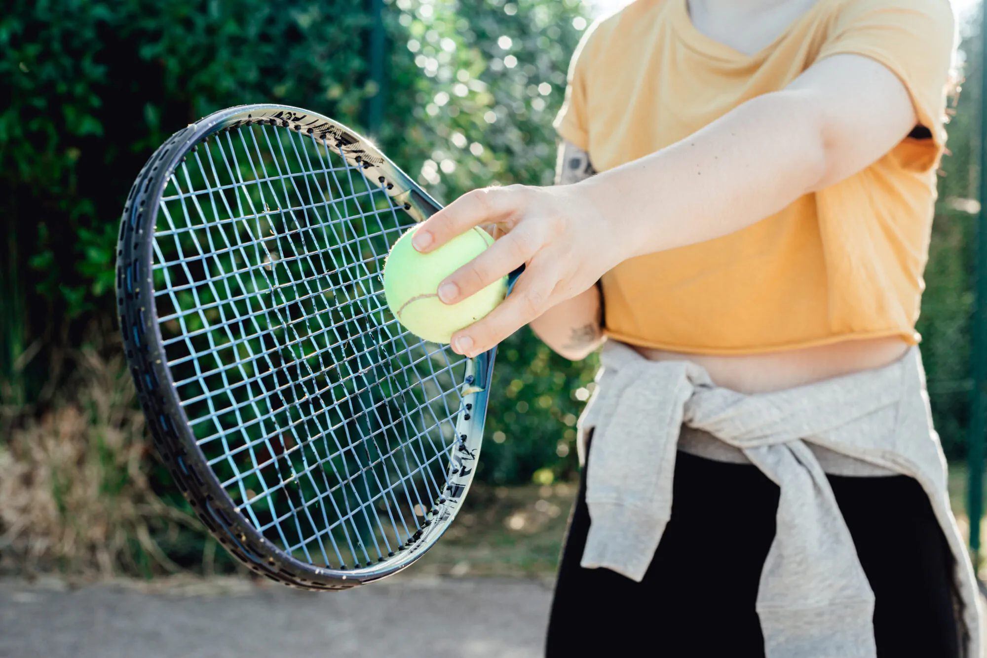 Close up image of a tennis racket before serving to play the game,woman practicing, learning sports