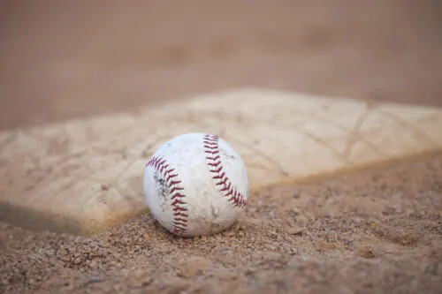 Selective focus low angle of grungy baseball and base