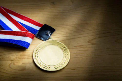 Generic sporting event gold medal with red and blue ribbon