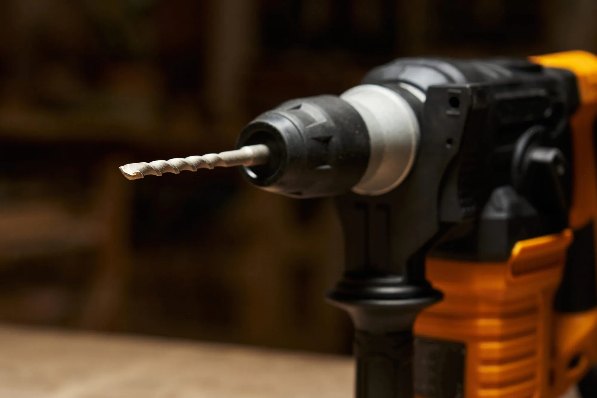 close-up and focus on the carbide tip of a drill bit inserted into a quick-change chuck