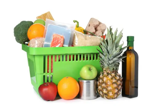 Shopping basket with different food products isolated on white