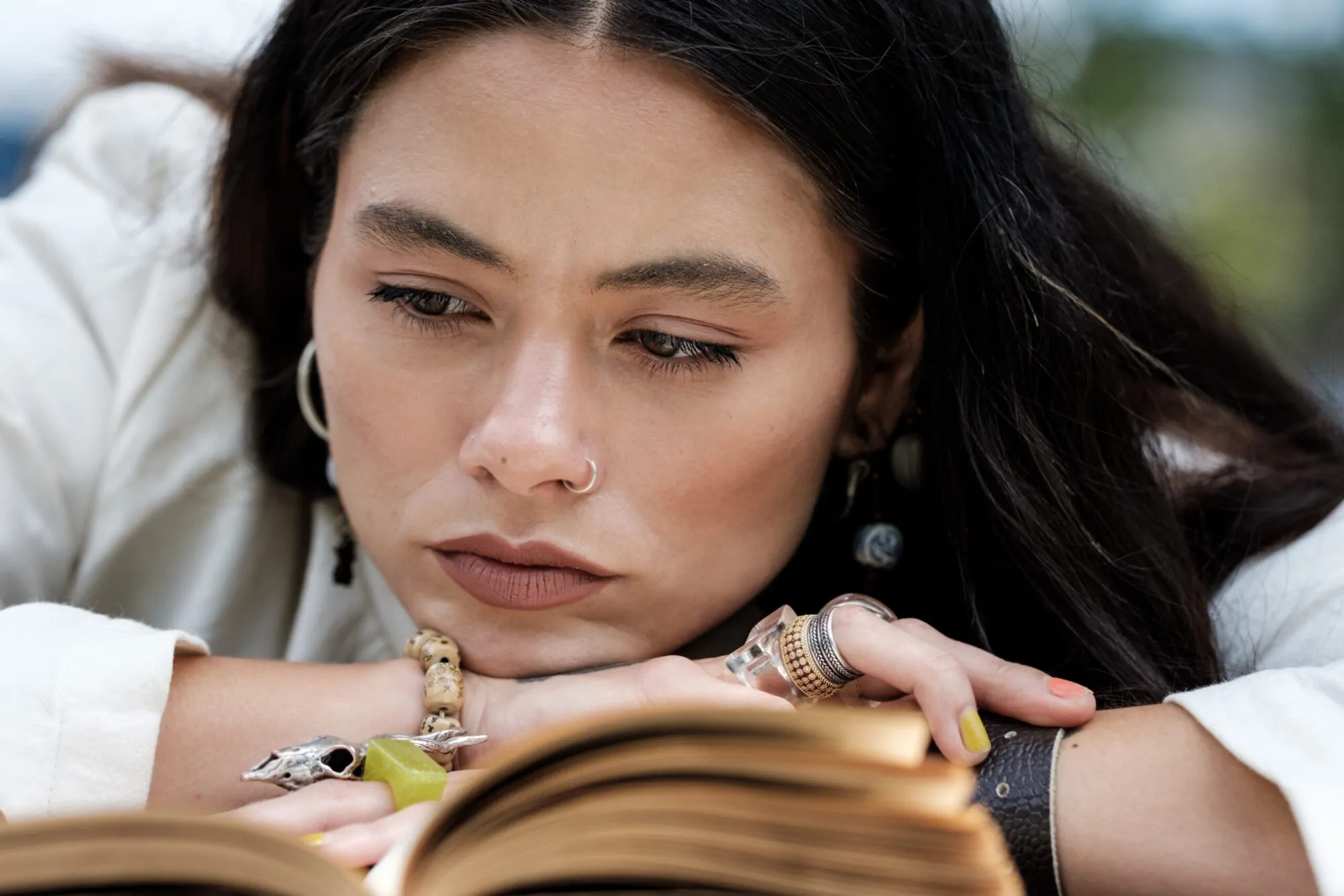 Close portrait of woman reading fascinating book.