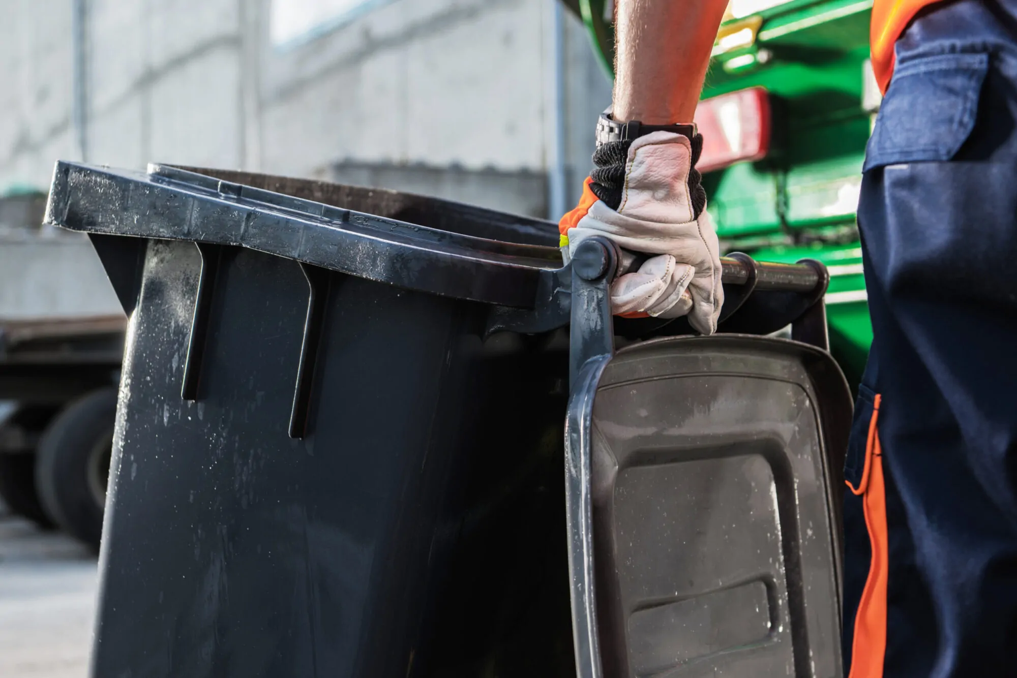 Garbage Truck Worker Moving Trash Can
