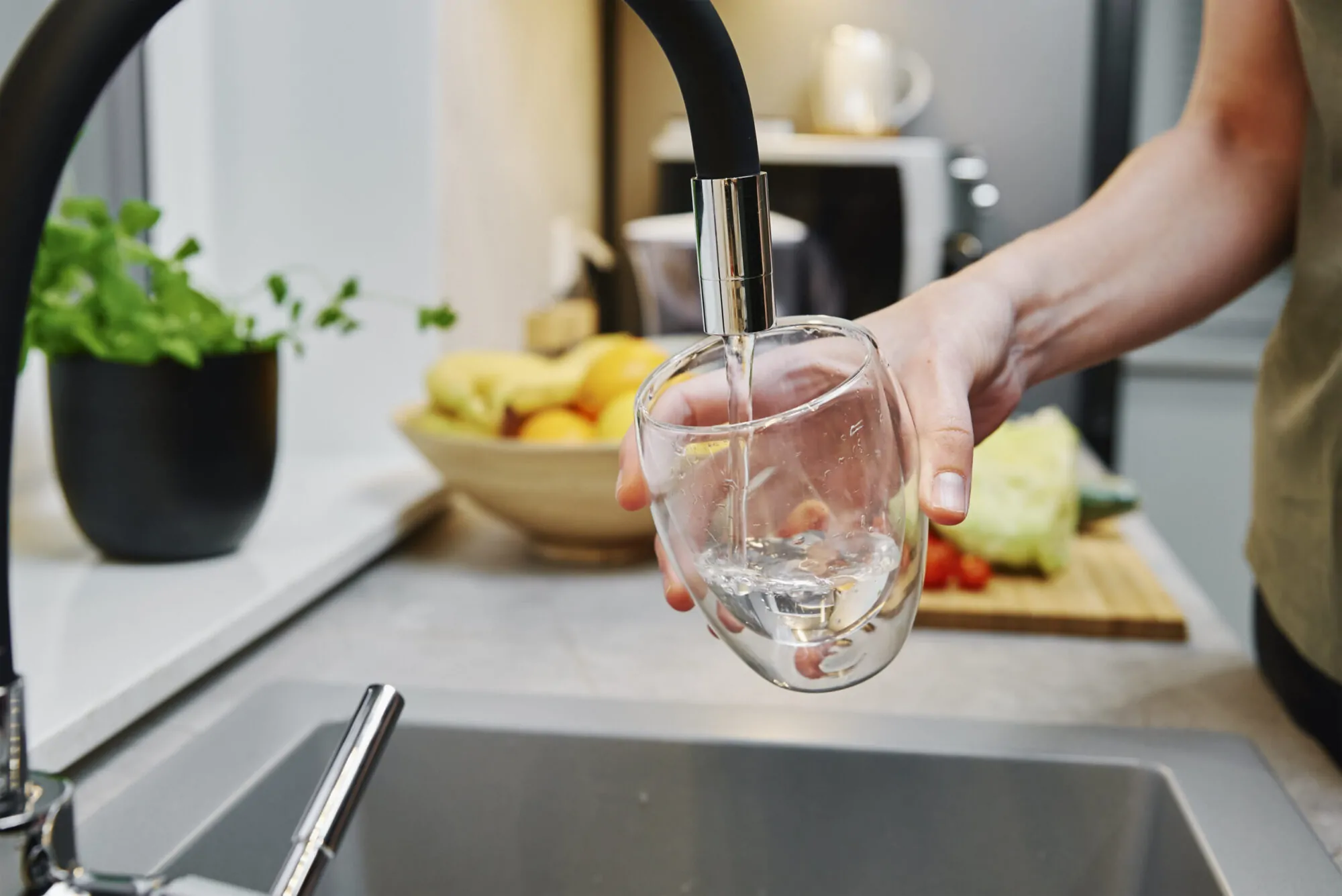 Woman pouring water in glass